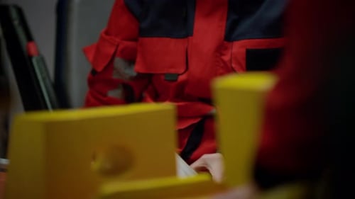 Paramedics Preparing Medical Equipment in Ambulance Interior