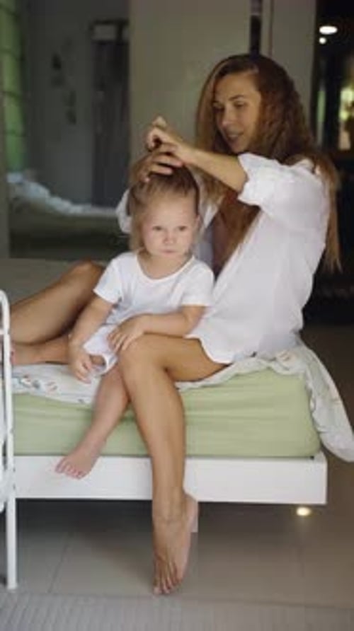 Woman Styling a Child's Hair in a Home