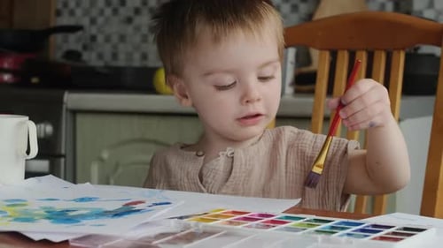 Toddler Boy Painting with Watercolours at Home