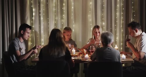 Family Meal Around Table with Candles and Lights