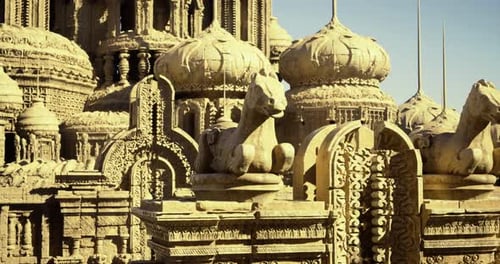 Intricate Stone Carvings of Historic Temple at Dawn with Domes and Sculptures