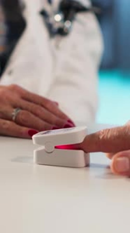 Doctor Checks Patient's Oxygen Levels with Pulse Oximeter