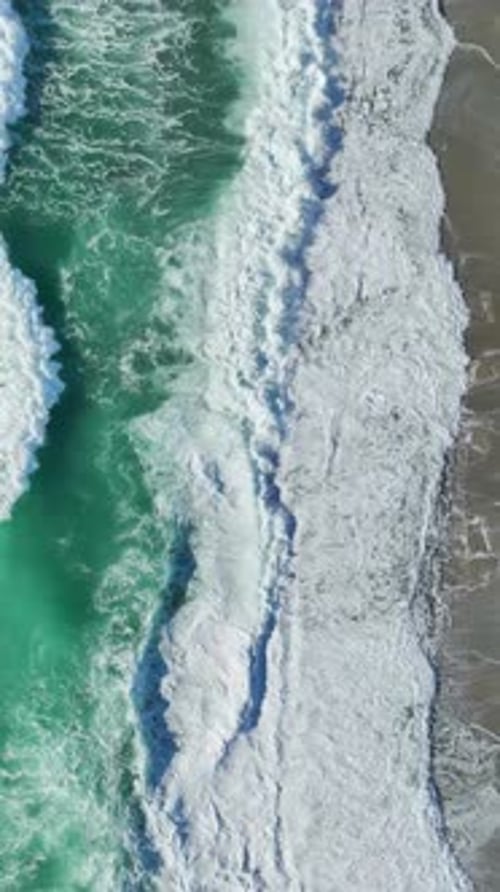 Aerial View of Turquoise Ocean Waves Crashing on Beach