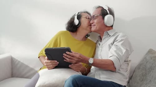 Elderly Couple Listening Music Together at Home