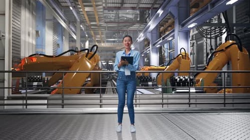 Woman Uses Tablet in Modern Automated Factory