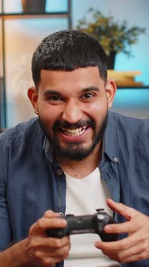 Excited Young Man Playing Video Games