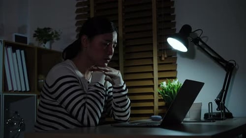 Woman Working Late at Night on Laptop