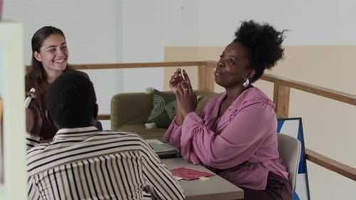 Three Colleagues Having Collaborative Brainstorm Meeting at Office Table