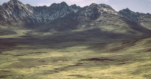 Majestic Mountain Range with Green Valley During Daylight Hours
