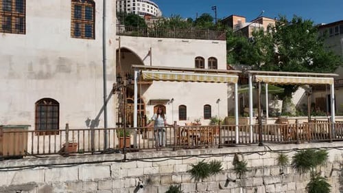 Woman on Balcony of Beautiful Building in City
