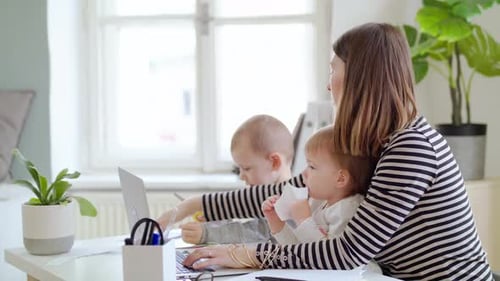 Mother with Two Small Children Working in Home Office Quarantine Concept