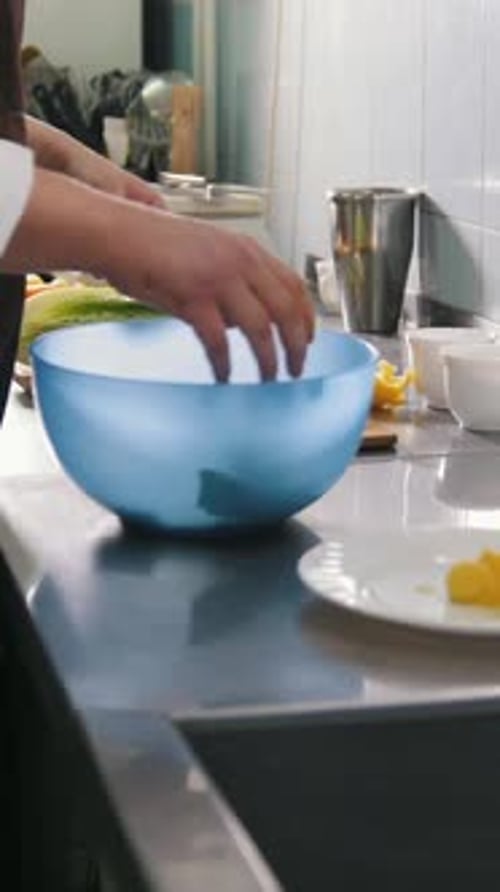 Male Chef Preparing Salad in Commercial Kitchen or Restaurant