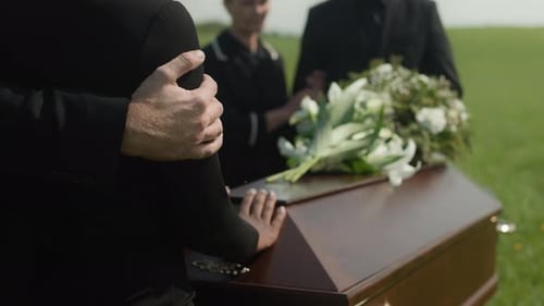 Attending Funeral with Coffin and Flowers