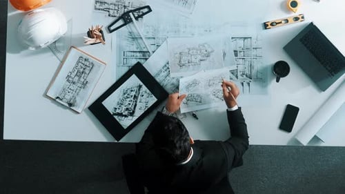 Top view of skilled engineer selecting material for house design. Alimentation.