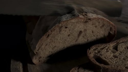 Slicing Rustic Bread on Wooden Surface