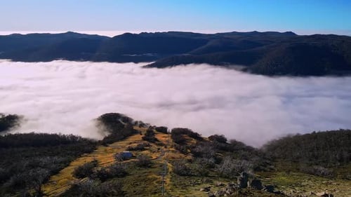 Above the Clouds Aerial View of Foggy Mountains and Rolling Green Hills