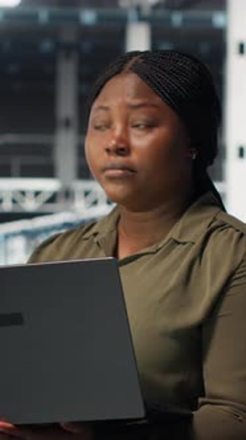 Vertical Video Technician in Server Farm Using Laptop to Upgrade Rigs