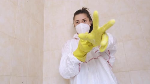 Young Adult Demonstrates Cleanliness With Soapy Gloves