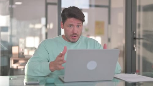 Adult Man Shocked by Laptop in Office