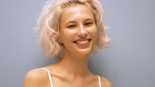 Young beautiful blond woman posing in studio