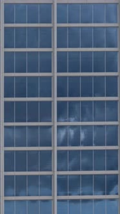 Clouds Passing in Reflection of Glass Windows of Skyscraper