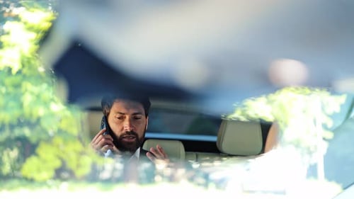 Man in Car Talking on Cell Phone