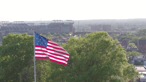 American Flag Waving Over Baltimore City Skyline