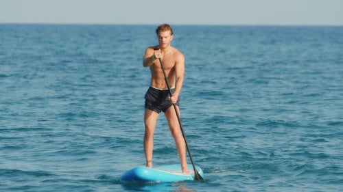 Man Navigate with Stand Up Paddle in the Sea