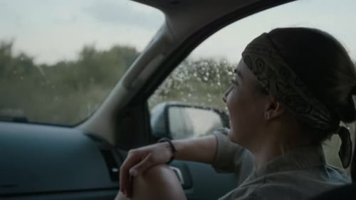 Cheerful Girl Chatting to Car Driver and Laughing while Traveling in Countryside