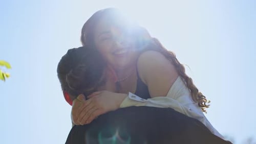 Happy Couple Embracing in Sunny Outdoor Setting