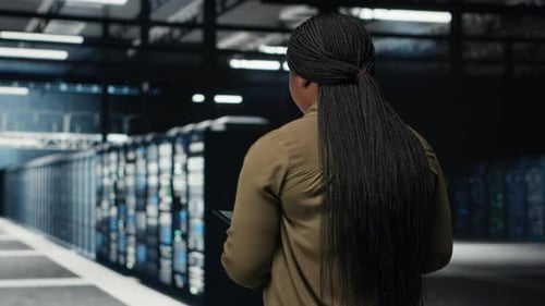 Engineer Working in Data Center Managing and Optimizing Network