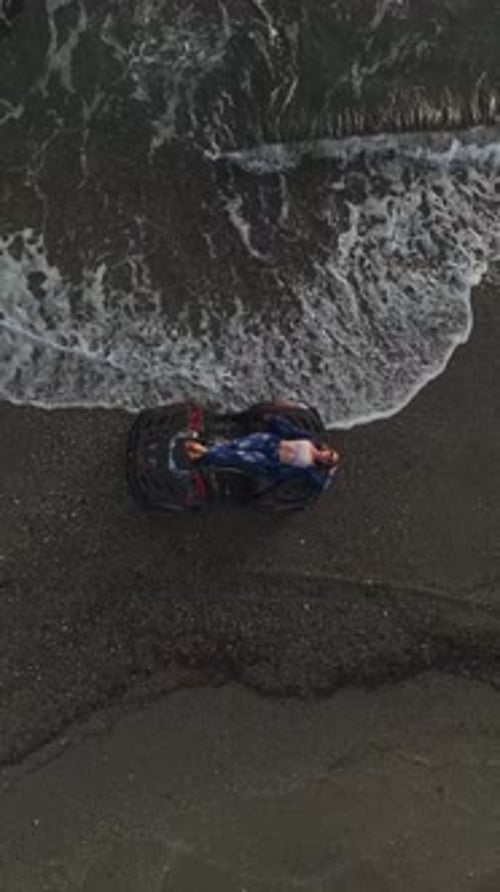 Vertical Video ATV Adventure Meets Glamour As a Model Poses By the Mediterranean Coastline