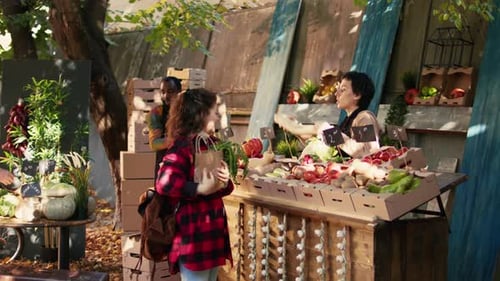 Woman Buying Produce at Outdoor Farmers Market