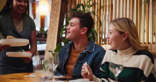 Food, serving and waitress with couple in restaurant with culinary Asian cuisine for date