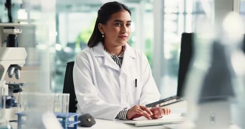 Woman Scientist Using Computer in Modern Laboratory