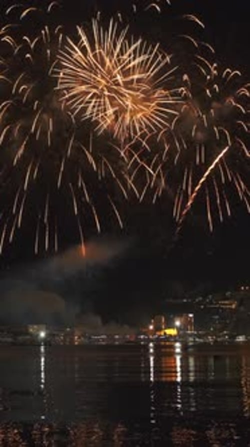 Fireworks with colorful lights over sea