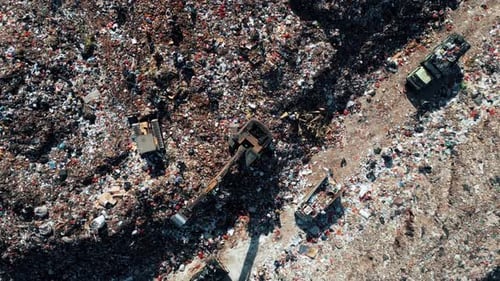Large Waste Dump and Trash Truck with Garbage in Aerial Top View