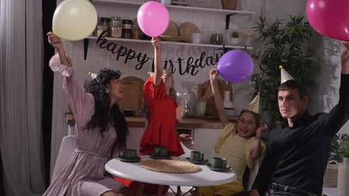 Family Celebrating Birthday with Balloons in Kitchen