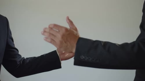Welcome Gesture Strong Male Friendly Handshake with Hands in a Business Suit on a White Background