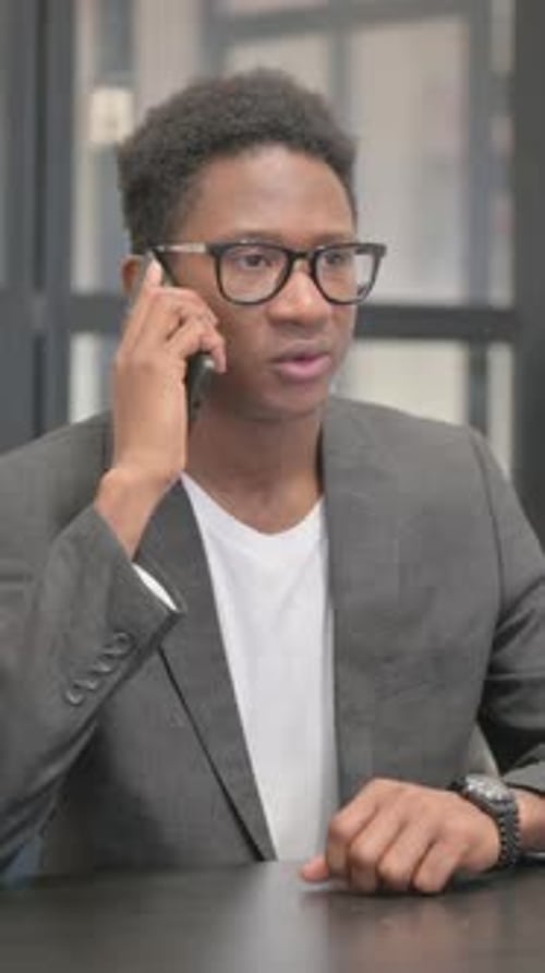 Vertical, African American Man Talking on phone in Office