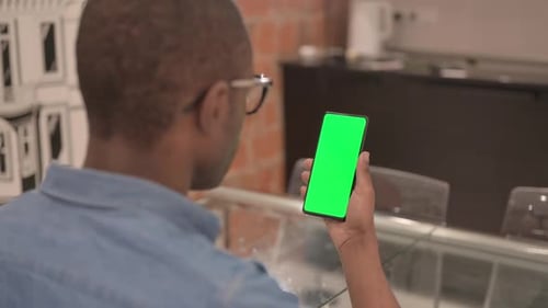 Close Up of African Man Using Phone with Green Screen