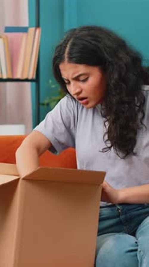 Woman Opens Box, Looks Confused, Checks Phone