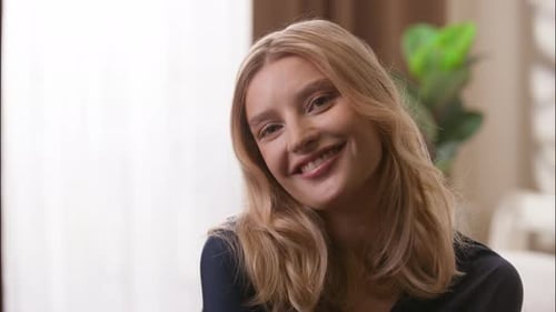 Woman Smiles with Blonde Hair Indoors