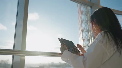 Woman Using Tablet by Sunny City Windows