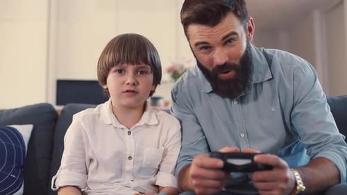 Father and Son Play Video Game Together, Celebrate Victory
