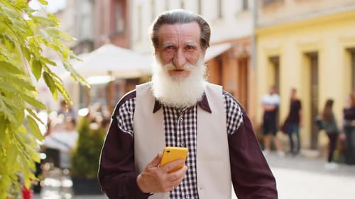 Senior Man Using Smartphone in City Street