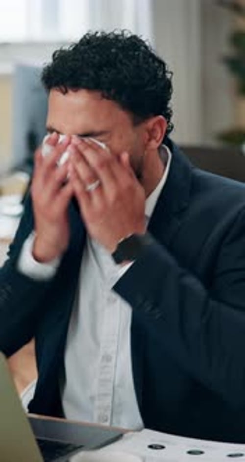 Business, person and sneeze at laptop in office, allergies or tissue for cleaning