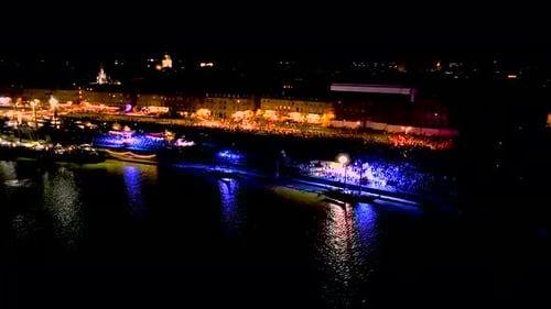 Garonne river shore at night in Bordeaux France during Wine Fair with large crowds celebrating, Aeri