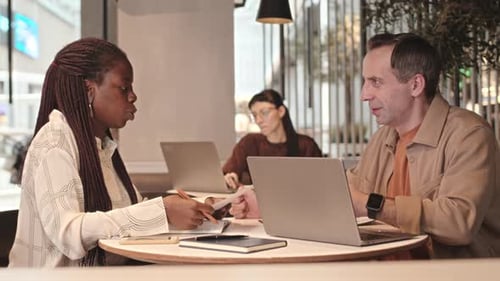 Diverse Colleagues Having Business Meeting in Cafe