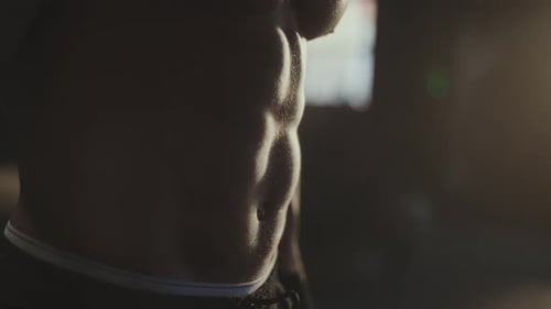 Man Working Out Arm Muscles in Gym